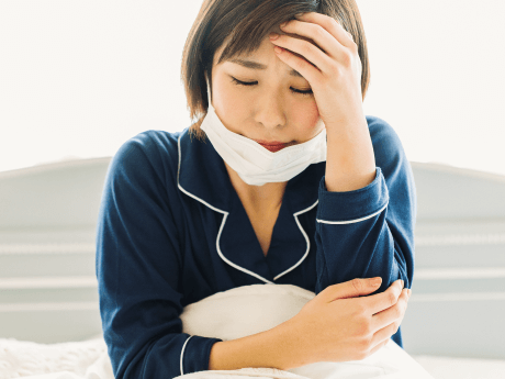 体調の悪い女性
